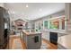 Open kitchen showcasing granite countertops, central island, modern appliances and sun-filled window at 7414 S Monroe Ct, Centennial, CO 80122