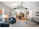 Bright living room with open kitchen, comfortable seating, vaulted ceiling and seamless indoor-outdoor flow at 7414 S Monroe Ct, Centennial, CO 80122