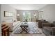 Comfortable living room with neutral tones, plush seating and large window at 7414 S Monroe Ct, Centennial, CO 80122