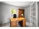 Bright office space with classic wooden desk, chair, and ample natural light at 7414 S Monroe Ct, Centennial, CO 80122