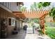 Outdoor patio with pergola, dining set, grill, and well-manicured lawn at 7414 S Monroe Ct, Centennial, CO 80122