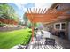 Outdoor patio area with stone flooring, pergola, and seating at 7414 S Monroe Ct, Centennial, CO 80122