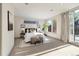 Bright bedroom features neutral decor, stylish art, and large windows providing access to a private outdoor space at 3615 Navajo St, Denver, CO 80211