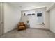 Cozy carpeted bedroom with leather chair, side table, and natural light at 3615 Navajo St, Denver, CO 80211