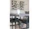 Close up of a sleek modern dining table with chairs, white vase, and contemporary art at 3615 Navajo St, Denver, CO 80211