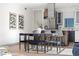 Modern dining area with a sleek table, stylish chairs, and contemporary artwork, next to the kitchen at 3615 Navajo St, Denver, CO 80211