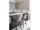 Modern kitchen featuring sleek wood cabinets, white countertops, and stylish counter stools at 3615 Navajo St, Denver, CO 80211