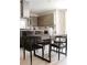 Bright kitchen boasts a stainless steel hood vent, gas range on island, and views to an adjacent dining area at 3615 Navajo St, Denver, CO 80211