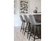 A close-up of kitchen bar stools in front of modern art on the kitchen wall at 3615 Navajo St, Denver, CO 80211