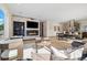 Bright living room with hardwood floors, stone fireplace, built in shelving, and an open floor plan to the kitchen at 3615 Navajo St, Denver, CO 80211