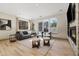 Bright living room features a stone fireplace, large windows, and neutral decor, creating a comfortable and inviting atmosphere at 3615 Navajo St, Denver, CO 80211