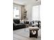 Cozy living room featuring modern furnishings, a stylish rug, and a large window providing natural light at 3615 Navajo St, Denver, CO 80211