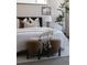 Comfortable main bedroom with a luxurious bed, soft pillows, and stylish ottomans at 3615 Navajo St, Denver, CO 80211