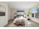 Bright main bedroom with large windows, two ottomans, and neutral decor at 3615 Navajo St, Denver, CO 80211