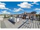 Rooftop deck with outdoor seating and cityscape views on a sunny day at 3615 Navajo St, Denver, CO 80211