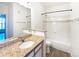Bathroom featuring a granite countertop, a large mirror, and a shower-tub combination at 7483 S Quail Cir # 635, Littleton, CO 80127