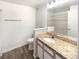 Bright bathroom features a granite countertop vanity and a large mirror at 7483 S Quail Cir # 635, Littleton, CO 80127