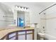 Bathroom features a large countertop space with double mirror, shower and tub combo at 7483 S Quail Cir # 635, Littleton, CO 80127