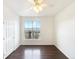 Empty bedroom boasts wood floors, white walls, a ceiling fan, and a neighborhood view at 7483 S Quail Cir # 635, Littleton, CO 80127