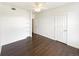 Spacious bedroom with dark wood floors, ceiling fan, and multiple access doors at 7483 S Quail Cir # 635, Littleton, CO 80127