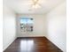 This bedroom features a large window providing natural light and dark hardwood floors at 7483 S Quail Cir # 635, Littleton, CO 80127