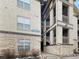 Condominium exterior showcasing stone accents, neutral stucco, and stairs to upper levels at 7483 S Quail Cir # 635, Littleton, CO 80127
