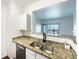 Kitchen view shows granite countertops, stainless steel appliances, and an open breakfast bar at 7483 S Quail Cir # 635, Littleton, CO 80127