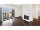 Living room featuring dark hardwood floors, a sliding glass door, and a fireplace at 7483 S Quail Cir # 635, Littleton, CO 80127