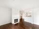 Bright living room with white fireplace, wood floors and open view to kitchen and office space at 7483 S Quail Cir # 635, Littleton, CO 80127