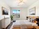 This bedroom boasts a large window, wood floors, a ceiling fan, and neutral decor at 7483 S Quail Cir # 635, Littleton, CO 80127