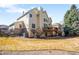 A spacious backyard featuring a well-maintained lawn and a charming elevated deck, ideal for outdoor relaxation at 9556 Kemper Dr, Lone Tree, CO 80124