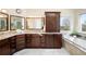 Bathroom features a granite countertop, cabinets, and a soaking tub under a window with a view at 9556 Kemper Dr, Lone Tree, CO 80124