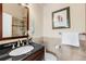 Bathroom with dark brown vanity and a glass shower with granite tiles at 9556 Kemper Dr, Lone Tree, CO 80124