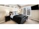 Cozy bedroom with a black bed frame, stylish decor, and a bright window at 9556 Kemper Dr, Lone Tree, CO 80124