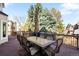 Inviting outdoor deck with a dining set and room to relax amidst a backdrop of lush trees and serene ambiance at 9556 Kemper Dr, Lone Tree, CO 80124