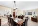 Elegant dining room with large windows, wood table, and comfortable seating arrangement for Gathering gatherings at 9556 Kemper Dr, Lone Tree, CO 80124