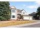 Elegant two-story home with well-manicured front yard and a three-car garage, blending style with functionality at 9556 Kemper Dr, Lone Tree, CO 80124