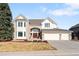 Charming two-story home features a three-car garage, well-manicured lawn and beautiful brick and siding at 9556 Kemper Dr, Lone Tree, CO 80124