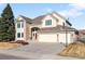 Charming two-story home featuring a well-maintained lawn, a three-car garage, and a welcoming front entrance at 9556 Kemper Dr, Lone Tree, CO 80124