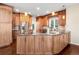 Gourmet kitchen with custom cabinetry, stainless steel appliances, hardwood floors, and expansive countertops at 9556 Kemper Dr, Lone Tree, CO 80124