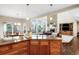 Open-concept kitchen with island seating, granite countertops, stainless appliances, and seamless flow to living area at 9556 Kemper Dr, Lone Tree, CO 80124