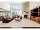 Bright living room with soaring ceilings, large windows, a cozy fireplace and a seamless open concept design at 9556 Kemper Dr, Lone Tree, CO 80124