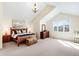 Spacious main bedroom features vaulted ceilings, a large window with backyard views, and wood furniture at 9556 Kemper Dr, Lone Tree, CO 80124