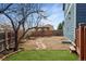 Backyard featuring a stone walkway, wooden pergola, and well-maintained lawn space at 16191 E Hinsdale Ln, Aurora, CO 80016
