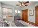 Cozy bedroom featuring wood floors, a ceiling fan, and natural light, perfect for relaxation and restful nights at 16191 E Hinsdale Ln, Aurora, CO 80016