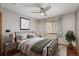 Cozy bedroom features a black metal bed frame, ceiling fan, and a window for natural light at 16191 E Hinsdale Ln, Aurora, CO 80016