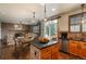 Open-concept kitchen with granite countertops, stainless steel appliances, and a view of the cozy fireplace at 16191 E Hinsdale Ln, Aurora, CO 80016