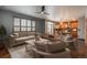 Bright and airy living room with hardwood floors, stylish furniture, and seamless flow into the modern kitchen at 16191 E Hinsdale Ln, Aurora, CO 80016