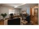 Well-lit home office with a large desk, bookshelves, and comfortable seating at 16191 E Hinsdale Ln, Aurora, CO 80016