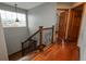 Staircase with wooden steps, decorative wrought iron railing, and a large window at 16191 E Hinsdale Ln, Aurora, CO 80016